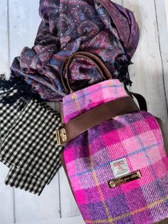 "MADE IN SCOTLAND, by a Scottish maker. Harris Tweed is a one-of-a-kind fabric, handwoven by individual artisans on Harris in the Outer Hebrides. Something this unique needs a handbag to match, and this bucket backpack handbag is just that! The certificate of authenticity is on the front. This bucket bag is unique with its lock strap closure, cute handles, and adjustable backpack straps. Featuring a Harris Tweed print on the front panel (with authenticity label), with brown vegan leather back panel and straps, this is a unique backpack, big enough for daily essentials. On the inside you'll find a wide slip pocket divided into three sections, and a zip pocket. The lining fabric is a gorgeous print from artist Laura Muir's Moody Blooms collection. The gold hardware really elevates this bag, Backpack List, Harris Tweed Bag, Bucket Backpack, Tweed Bag, Unique Backpacks, Backpack Gift, Backpack Handbag, Outer Hebrides, Stylish Backpacks