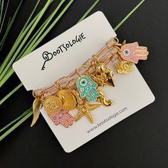 Hamsa Layers Bracelet - Bootsologie Bohemian Bracelet With Adjustable Cord, Trendy Adjustable Charms With Removable Features, Bohemian Wrap Bracelet With Adjustable Length As Gift, Adjustable Gold Bohemian Wrap Bracelet, Gold Adjustable Bohemian Wrap Bracelet, Bohemian Gold Resizable Friendship Bracelets, Gold Bohemian Resizable Friendship Bracelets, Adjustable Bohemian Wrap Bracelet As Gift, Trendy Adjustable Charm Bracelet With Removable Charms