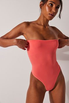 An effortlessly essential wardrobe staple, this go-to bodysuit is featured in a strapless style and ultra-comfy seamless construction. **Fit:** Pull-on style, thong bottom, high-cut legs **Features:** Strapless, tube style, smooth fabrication, seamless design **Why We | Tati Seamless Tube Bodysuit by Intimately at Free People in Orange, Size: M/L Bday List, Essential Wardrobe, Boho Clothing, High Cut, Boho Outfits, Wardrobe Staples, Wardrobe Essentials, Free People, Coral