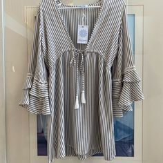 Grey And White Striped With Tie Front And Mid Length Bell Sleeves. 100% Rayon. Size Small, Never Been Worn With Original Tag. Casual V-neck Beach Dress For Day Out, Striped V-neck Blouse For Vacation, Beachy V-neck Top For Day Out, Casual Striped Beach Blouse, Striped Summer Blouse For Day Out, Casual V-neck Cover-up For Brunch, Chic Striped Top For Vacation, Chic Long Sleeve Tops For Vacation, Beachy V-neck Cover-up For Brunch