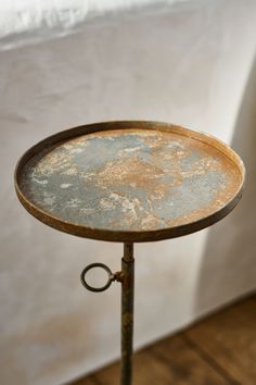 an old metal table with rusted paint on it