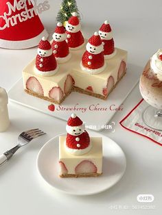 a white plate topped with slices of cheesecake covered in strawberries and santa hats