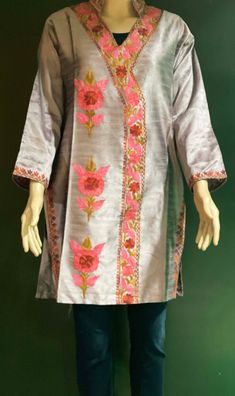 Embroidered Tunic Crafted from raw Silk, designed in Classic Kashmiri Aari embroidery.  Match it with a pair of denims or leggings perfect for Women and Girls a classic tunic that never goes out of fashion. ThisTunic features intricate  embroidery on the neckline, sleeves, the side hem and motif on the front. A combination of vibrant shades with a beautiful play of colors. Color: silk Pink -Color can vary due to lighting. All sizes  are approx.  Size: USA, M  Chest:38 inch.  Shoulder: 17 inch.  Sleeve length: 18 inch  Length: 33 inch. Fabric: Raw Silk- Dry clean or hand wash, iron on low heat. Made in a smoke and pet free home. Made in Kashmir, India Traditional Chanderi Kurta With Embroidered Neckline, Chanderi Resham Embroidery Straight Kurta Top, Straight Kurta Top With Resham Embroidery In Chanderi, Navratri Floral Embroidered Raw Silk Kurta, Bollywood Style Kurta With Embroidered Neckline For Eid, Bollywood Style Festival Kurta With Embroidered Neckline, Bollywood Style Embroidered Kurta For Festivals, Festive Bollywood Traditional Wear With Embroidered Neckline, Embroidered Neckline Kurta For Summer Festivals