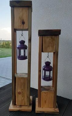 two wooden lanterns sitting on top of a table