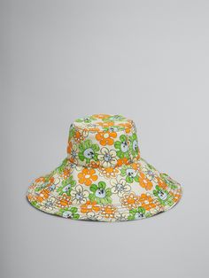 an orange and green hat with flowers on it