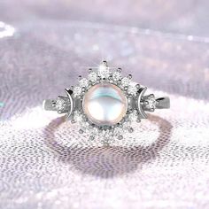 Elevate Your Ritual with Our Enchanting Opal Triple Moon Ring 🌙✨ Embrace the captivating power of the moon phases with our mesmerizing Opal Triple Moon Ring, a stunning piece of Wicca jewelry that celebrates the divine feminine. Crafted with stunning opal, this ring features the iconic triple goddess symbol, representing the Maiden, Mother, and Crone – the three phases of the lunar cycle. Whether you're a devotee of the Wiccan tradition, a practitioner of the magickal arts, or simply captivated by the allure of the moon, this Moon phases ring is the perfect accessory to adorn your ritual space and enhance your spiritual connection. The opal's iridescent shimmer and the intricate triple moon design make this ring a truly enchanting addition to your witchy jewelry collection. Elevate your m Celestial Moonstone Ring With Moon Charm, Magical Moon Shaped Ring With Moon Phase Detail, White Round Celestial Jewelry, Magical Moon Shaped Ring With Moon Phase, Magical Moon-shaped Ring With Moon Phase Details, Magical Moon-shaped Ring With Moon Phase, White Celestial Jewelry, White Moon Shaped Celestial Jewelry, White Moon-shaped Celestial Jewelry