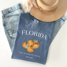 Cute Florida Oranges Tee Shirt, Sunshine State Tshirt, Comfort Colors Gift The Comfort Colors C1717 100% Ring Spun Cotton T-Shirt is very appropriately-named. All colors are inspired by nature and have a perfect lived-in, weathered look. Shirts are sent through a unique dyeing process that makes them incredibly soft and long-lasting. Each piece is soft-washed 50 times before making its way to you! Stitched at the collar, armhole, sleeves and bottom hem for ultimate durability, you will notice the density and quality of this shirt, but won't mind living in it. COMFORT COLORS 1717 ADULT TEE 6.1 Oz/SqYd 100% Ring Spun Cotton Soft-washed garment-dyed fabric Double-needle collar Twill taped neck and shoulders Twill label Relaxed fit Double needle armhole, sleeve and bottom hems Tubular body PRO Florida Shirt, Orange Tees, Perfect Live, Florida Oranges, Sunshine State, Casual Wardrobe, Look Plus, Favorite Shirts, Custom Clothes