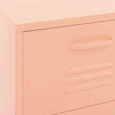 a close up of a pink drawer on a white wall with an object in the background