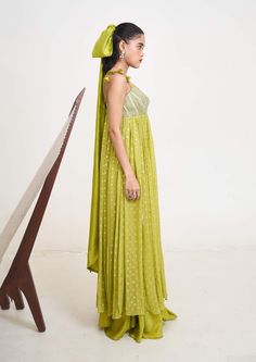 Introducing the emilie anarkali, a masterpiece crafted from the finest georgette and chanderi silk, now available in a captivating lime green hue. This ensemble exudes timeless elegance with its flowing silhouette and exquisite craftsmanship. Green Palazzo Set With Sheer Dupatta In Traditional Drape, Green Georgette Gown With Cutdana, Green Georgette Gown With Cutdana Detail, Green Silk Palazzo Set With Mirror Work, Green Cutdana Georgette Gown, Green Floor-length Palazzo Set For Navratri, Green Silk Anarkali Set, Pista Green Georgette Anarkali Set For Navratri, Green Silk Cutdana Dress