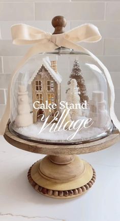 a cake stand with a glass dome on top that says cake stand village in front of it