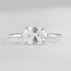 a white diamond ring sitting on top of a table