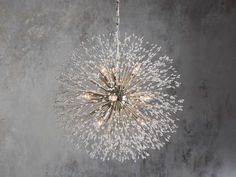 a chandelier hanging from the ceiling with lights on it and snow flakes