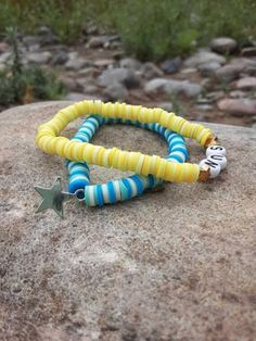 Summer may have ended, but we can keep the spirit alive with these bright, cheerful, and summery bracelets! ☀️ Picture yourself strolling along the beach, sipping on a cool drink, and flaunting these bracelets that scream summertime joy. 🏖️ Starstruck in Blue: One bracelet in this dynamic duo boasts a dazzling ocean blue hue, a true homage to those clear summer skies. Adorned with a twinkling star charm, it's your very own piece of the night sky right at your wrist. Whether you're a dreamer or just love a little celestial bling, this one's for you! 🌟 Here Comes the Sun: The second bracelet is a cheerful burst of sunshine itself! In radiant yellow, it practically screams sun! It's the perfect reminder to soak up these last rays and seize the day. Plus, you can wear these fabulous bracelet Colorful Beaded Yellow Bracelets For Vacation, Yellow Beaded Bracelets For Vacation, Yellow Bracelets With Round Beads For Vacation, Yellow Beaded Bracelets For Beach With Colorful Beads, Yellow Beach Jewelry For Vacation, Colorful Beaded Bracelets For The Beach, Yellow Beaded Bracelets With Colorful Beads For Beach, Fun Beaded Stretch Bracelet For Beach, Yellow Beaded Bracelet For Vacation