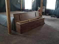 an unfinished bed frame in the middle of a room with no sheets or curtains on it