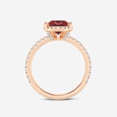 a rose gold engagement ring with an oval cut garnetia stone set in the center