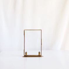 a white table with a gold frame on it