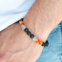 Infused With Ornate Silver Accents, An Earthy Collection Of Glassy Black Beads, Orange Stone Beads, And Black Lava Rock Beads Are Threaded Along A Stretchy Band Around The Wrist For A Seasonal Look. Sold As One Individual Bracelet. Male Bracelets Beads, Male Bead Bracelet, Male Beaded Bracelets, Male Bracelets, Mens Stretch Bracelets, Royal Au, Oc Reference, Mala Beads Bracelet, Reference Board