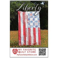 an american flag quilt on display with the words liberty written in black and white letters