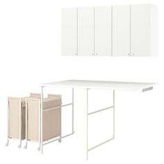 a white kitchen table with three storage bins on wheels and two cabinets above it