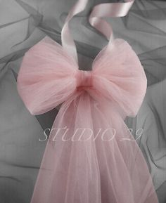 a pink tulle bag with a bow on it