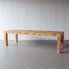 a wooden table sitting on top of a cement floor