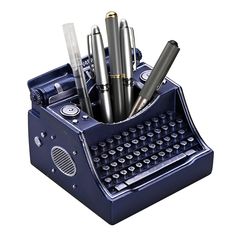 a blue typewriter pen holder with pens and pencils in it on a white background