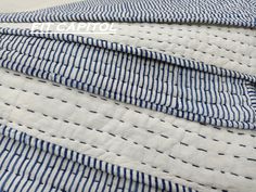 blue and white striped fabric with stitching on it