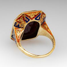 This unique and special circa 1900 Victorian intaglio ring features engraved details along the top and side faces with blue and orange enamel. The ring is accented with one (1) bezel set cut-cornered rectangular shaped intaglio cut garnet. The ring measures 20.7mm at the top, rises 6.5mm above the finger, tapering to 1.6mm wide and 1.0mm thick at the base of the shank. It is a size 4.75 and we are not offering resizing due to the enamel on the ring. It shows average wear for its age. Bear Face Drawing, Intaglio Ring, Old Boxes, Bear Face, Pretty Clothes, Memorial Jewelry, Blue And Orange, February Birth Stone, Amethyst Ring