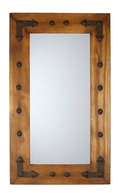 a wooden frame with metal fittings on the sides and a mirror in the middle