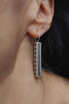 "These dangle geometric earrings have a horizontal rectangular shape, they are made of silver, the surface is hollow on the side has square gaps and the whole earring is covered with gray concrete, the finish is matte. These earrings are a trendy and special piece that can be worn with casual and formal outfits. It's perfect for making bold statements. DESCRIPTIONS and MEASUREMENTS: Material: Sterling Silver. Surface: Concrete  Dimensions : 3,5x0,5 (cm) 1,37x0,19 (in)\". thickness :0,5 (cm) 0,19 (in)\". Total Length :4,5 (cm) 1,77 (in)\". ΑLSO COMBINED WITH : www.etsy.com/shop/ArtisJewels?ref=seller-platform-mcnav&search_query=C5 Visit my Etsy shop, ArtisJewels, to see more earrings and jewelry and other unique handmade pieces. www.etsy.com/shop/ArtisJewels Do not hesitate to contact me fo Minimalist Silver Rectangular Earrings, Modern Silver Earrings With Rectangular Pendant, Modern Silver Rectangular Earrings, Modern Silver Rectangular Pendant Earrings, Silver Rectangular Everyday Earrings, Everyday Silver Rectangular Earrings, Single Silver Rectangular Earring, Everyday Modern Rectangular Linear Earrings, Rectangular Linear Earrings For Gift