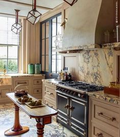 an old fashioned kitchen with marble counter tops and antique stove top ovens in the center