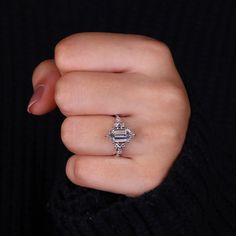 a woman's hand with a diamond ring on it