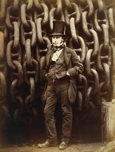 an old photo of a man standing in front of chains