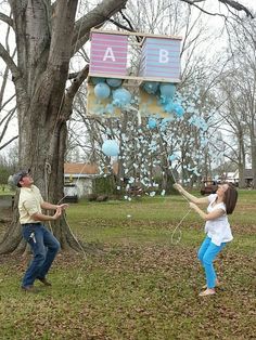 two people are playing with balloons in the yard