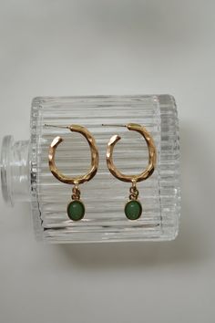 Our Dusk of Hope Earrings have a one of a kind twisted hoop that connects to a green pendant. These earrings are super light weight and dainty! Color - Green & Gold Material - Stainless Steel Measurements - 1.75 Inches Long Green Metal Dangle Hoop Earrings, Green Dangle Metal Hoop Earrings, Green Dangle Hoop Earrings In Metal, Green Circular Hoop Earrings As A Gift, Green Circular Hoop Earrings For Gifts, Green Circle Hoop Earrings As Gift, Green Circle Hoop Earrings For Gift, Trendy Green Dangle Hoop Earrings, Elegant Small Hoop Green Earrings