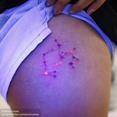 a woman's thigh with pink stars on it