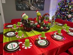 a table set for christmas with plates and cups