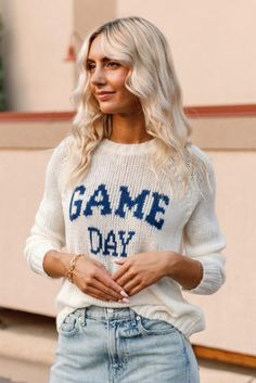 Product Details This incredibly soft and cozy crew features the phrase "Game Day" knit directly into the center front. With a relaxed fit and raglan sleeves this sweater has a sporty look. Additional details include ribbing on the neckline, cuffs and hem. Details & Fit Crew neck Light-weight cozy sweater knit Wide rib at neckline, cuff, and hem Raglan sleeve Length from shoulder to hem: 24" (size small) Materials & Care 76% acrylic, 12% mohair, 12% wool Machine Washable Collegiate Sweater For Game Day, Collegiate Long Sleeve Sweater For Game Day, White Long Sleeve Sweater For Game Day, White Fall Sweater For College, White Crew Neck Sweater For Game Day, Sporty Raglan Sleeve Sweater With Ribbed Cuffs, Collegiate Game Day Winter Sweater, Collegiate Sweater For Game Day In Winter, Collegiate Crew Neck Sweater With Ribbed Cuffs