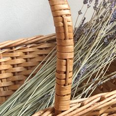 a wicker basket with lavender flowers in it