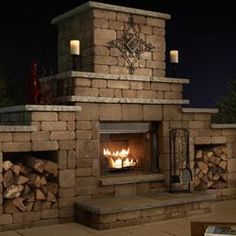 an outdoor fireplace is lit with candles