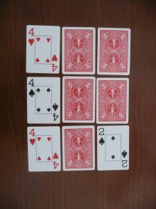 playing cards laid out on a wooden table