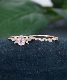 a close up view of an engagement ring with a pink diamond and white diamonds on it