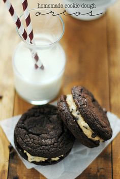 two cookies and milk on a wooden table