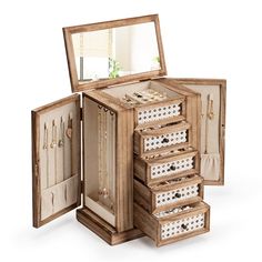 an open wooden jewelry box with drawers and mirrors on the top, inside which are white polka dots