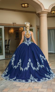 Navy blue high neck quinceanera ball gown with silver lace embroidery. Royal Blue Royal Ball Gown For Quinceanera, Royal Blue Ball Gown For Quinceanera, Fitted Blue Quinceanera Dress For Sweet 16, Royal Fitted Ball Gown For Quinceanera, Quinceanera Ball Gown With Lace Bodice, Royal Ball Gown For Quinceanera, Royal Blue Gown For Quinceanera, Blue Quinceanera Dress For Sweet 16, Blue Ball Gown Quinceanera Dress For Gala