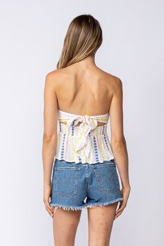 Nothing is as perfect as a sunshine-filled day and the Amelia White Embroidered Strapless Top! Lightweight, woven fabric shapes this ideal summer top that features a white embroidered print throughout as it shapes a strapless bodice that wraps around and ties in the back, a smocked waist, and flouncy, slightly cropped peplum hem. DETAILS & CARE Rayon/LINING: Polyester. Hand Wash Cold. Imported. ORDERS, SHIPPING & RETURNS Orders, Shipping, & Returns Strapless Cotton Crop Top For Beach, Strapless Summer Tops For Spring, Strapless Tops For Spring And Summer, Strapless Crop Top For Summer, Spring Bandeau Tube Top For Day Out, Cotton Strapless Tube Top For Summer, Strapless Cotton Top For Vacation, Strapless Cotton Tube Top For Day Out, Strapless Summer Crop Top