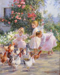 two children are playing with chickens in front of some flowers and bushes, while another child is on the ground next to them