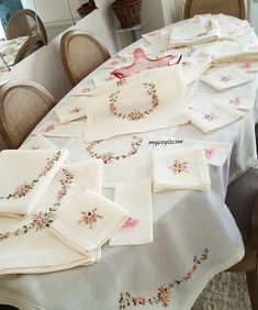 the table is covered with embroidered napkins and place mats