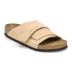 The Kyoto slide maximizes your comfort with its minimalist design. A nubuck leather hook-and-loop strap hugs the foot just right creating the perfect fit day-to-day. It's all grounded in our contoured footbed designed to shape to you with wear for the ultimate in support. Contoured cork-latex footbed creates custom support with wear Grained nubuck leather upper Suede footbed lining helps keep you comfortable Flexible EVA sole Hook-and-loop strap Made in Germany Leather Slide Sandals With Textured Footbed, Leather Slip-on Footbed Sandals With Textured Footbed, Leather Slides With Textured Footbed And Round Toe, Beige Leather Outdoor Sandals, Modern Leather Sandals With Cushioned Footbed, Beige Leather Sandals For Outdoor, Modern Leather Footbed Sandals With Cushioned Footbed, Outdoor Beige Leather Sandals, Beige Leather Footbed Sandals With Cushioned Sole