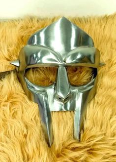 Tribute to Legend Singer MF Doom 1. It's limited Eddition Mf doom mask. 2. Perfect Mirror Chrome Finish. 3.it's also Anti Rust Mask. 4. You can choose material according to your desier. 5. It has 2 spikes in sides as same as On Legend MF Doom Mask. 6. It Also Have Adjustable Leather Straps so you can Comfortably Wear it. 7. It Has a artifical Gem stone on Forhead. 8. Overall Length : 9.75 ( Approx ) 9. Width : 8.25 ( Approx ) 10. If we talk about size so it comes in free size which is suitable f Mad Villain, Doom Mask, Mf Doom Mask, Doom 1, Party Mask, Mf Doom, Sculpture Projects, Best Face Mask, Mask Party